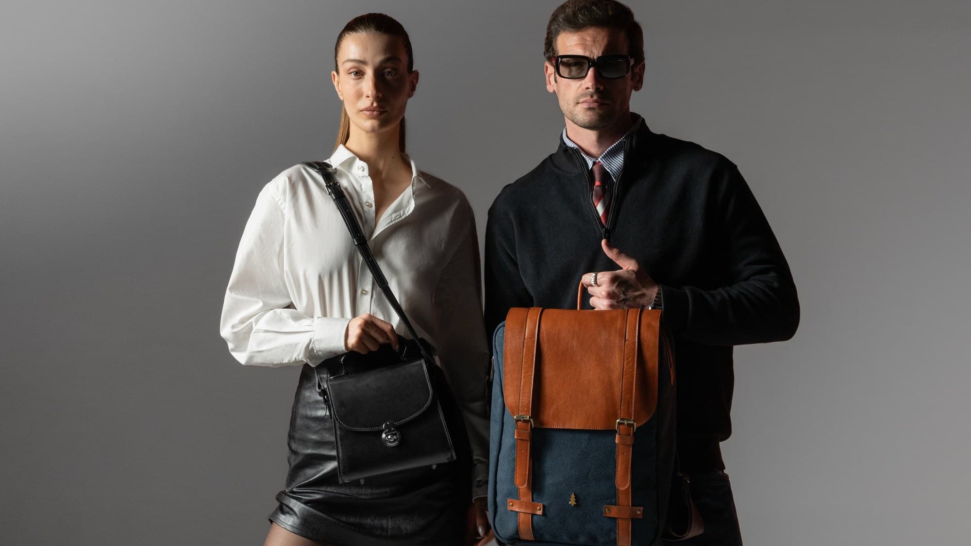 ARAS PINE — black shoulder bag and tan-and-canvas backpack, worn together