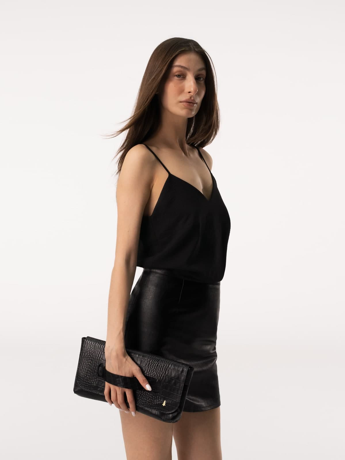 ARAS PINE Venera Clutch — black croc-embossed — Black silk cami, black leather mini, the croc-embossed flap catching the studio light — the evening piece, before the evening.