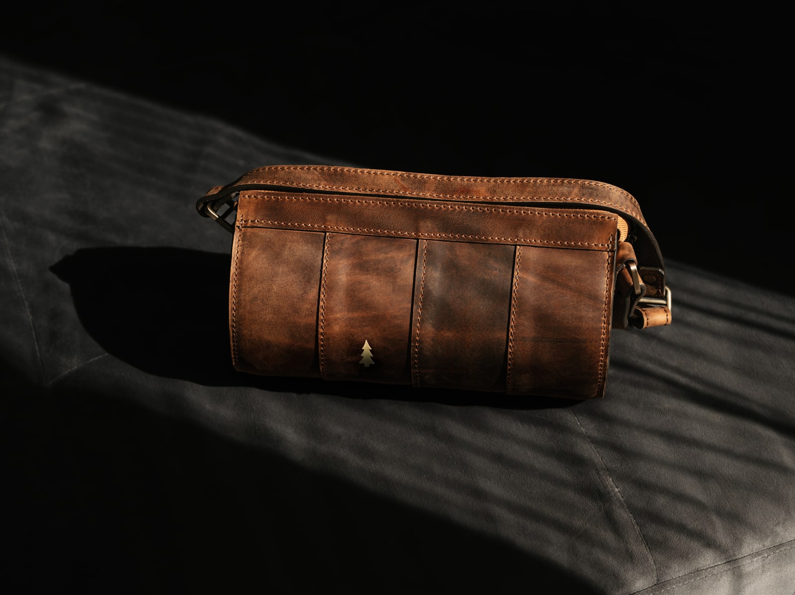 ARAS PINE Barca Crossbody — chestnut, side-lit against a dark suede backdrop with the strap removed — leather crossbody bag, handmade in Türkiye